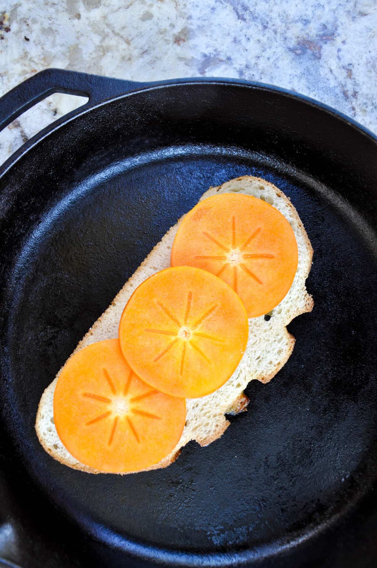 Sliced persimmon on sourdough bread