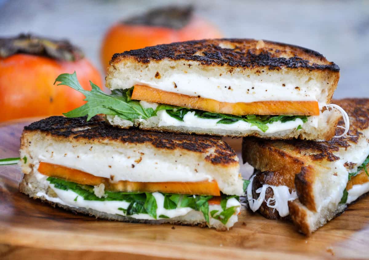 A persimmon grilled cheese sliced open to reveal the inside.
