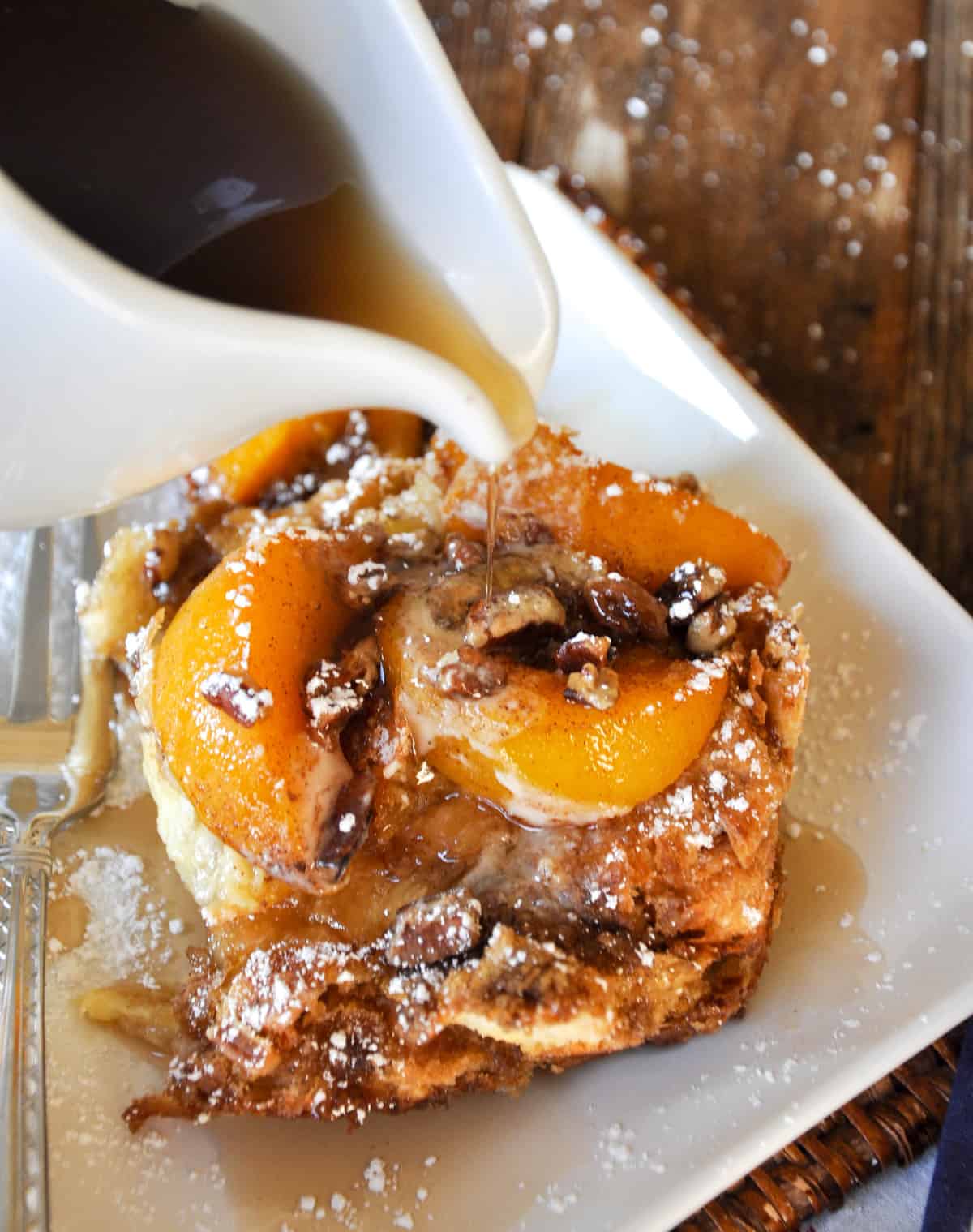 Maple Syrup poured over Peaches and Cream Overnight French Toast