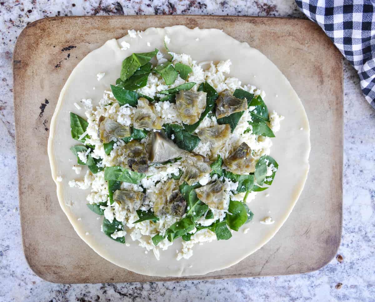 Chopped artichokes added to pie crust