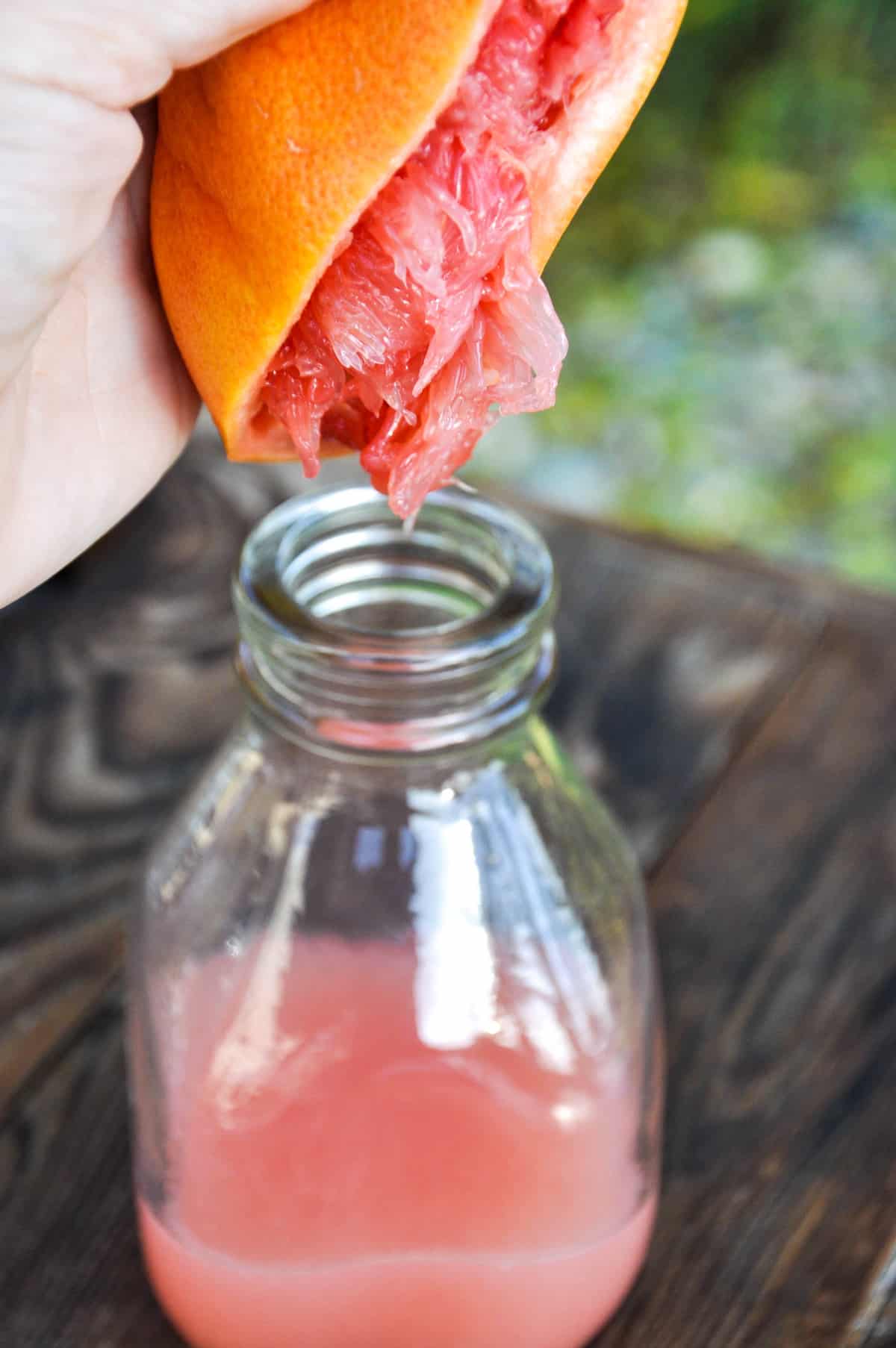 Squeezing grapefruit into jar