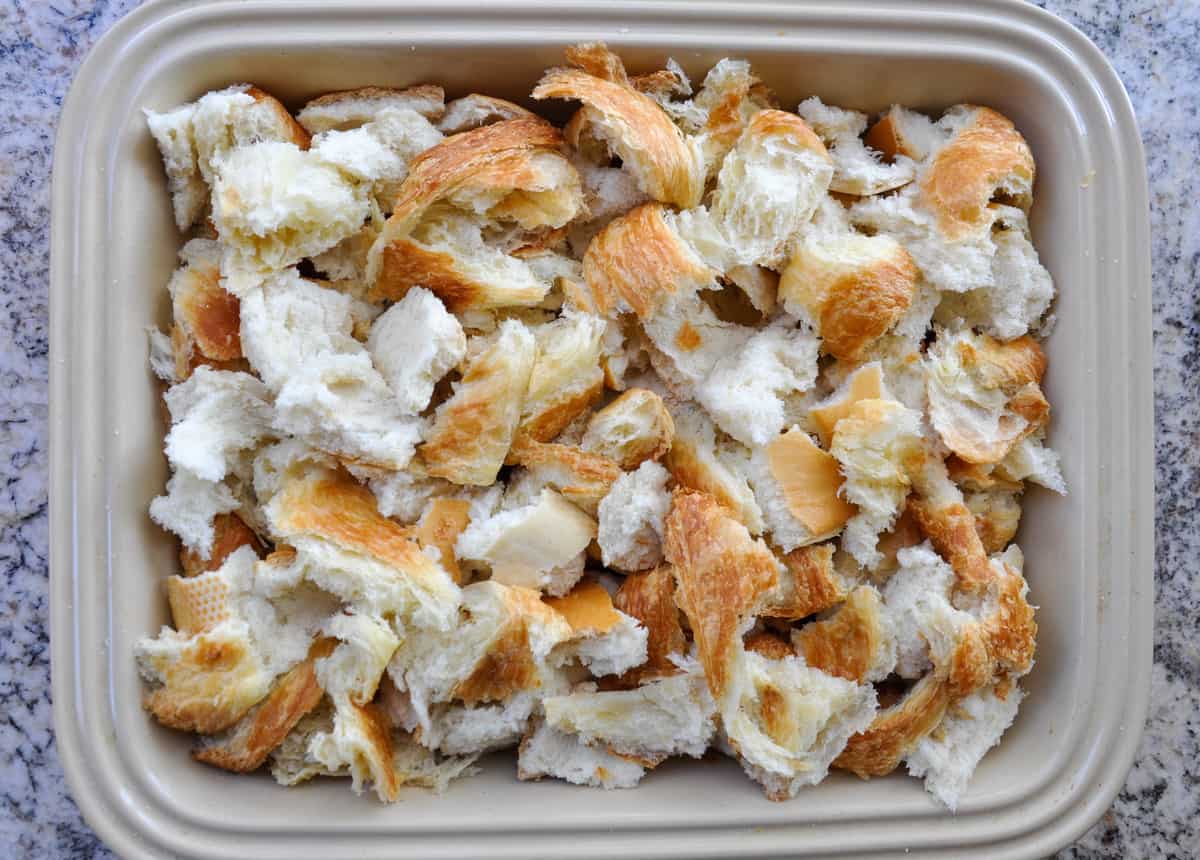 Torn pieces of bread in baking dish