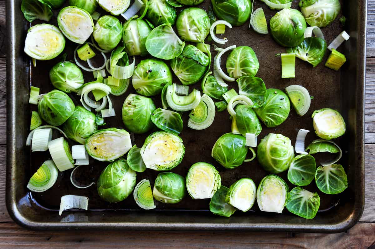 Sliced Brussels sprouts and leeks on baking sheet