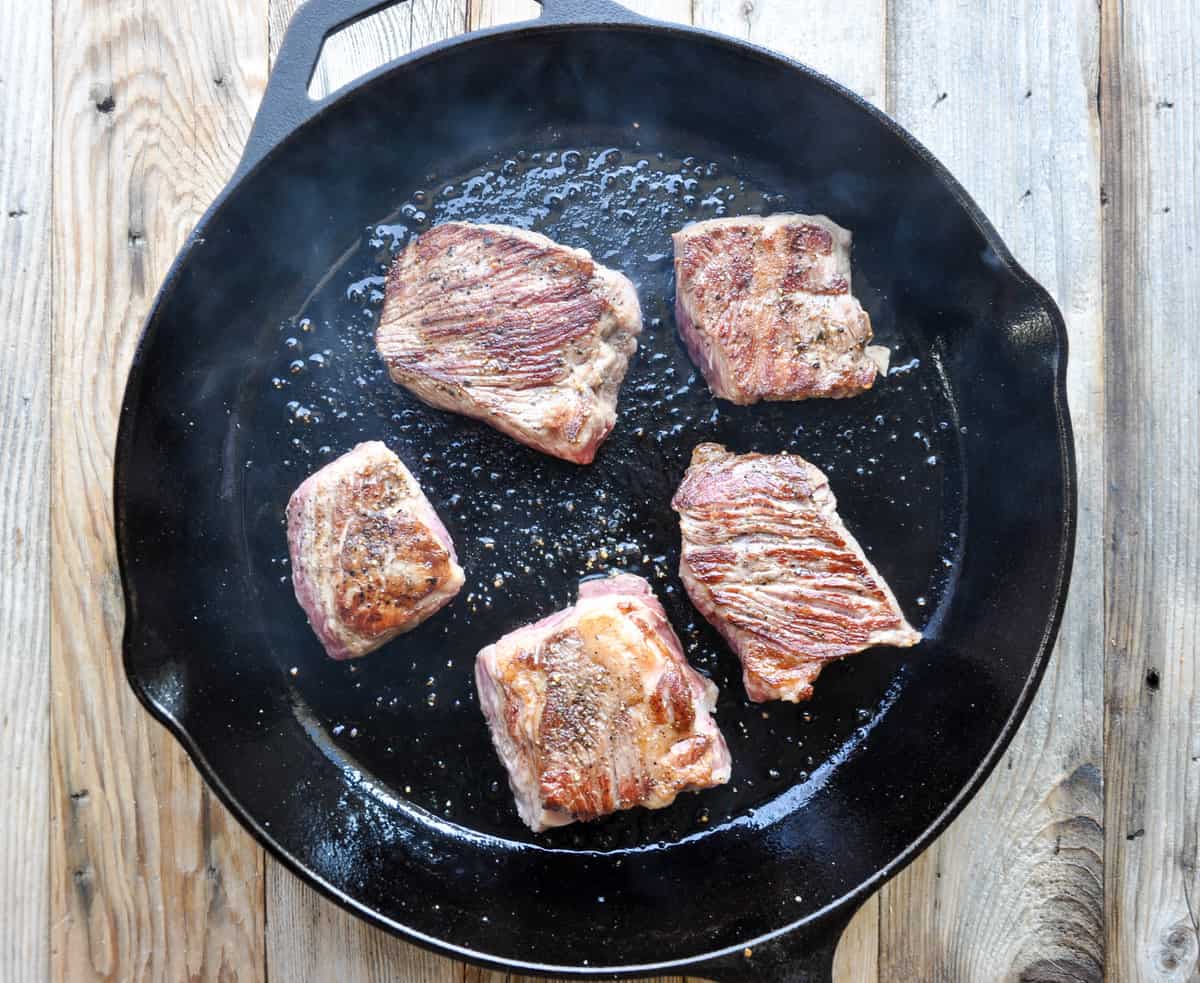 Cut chuck roast cooking in skillet