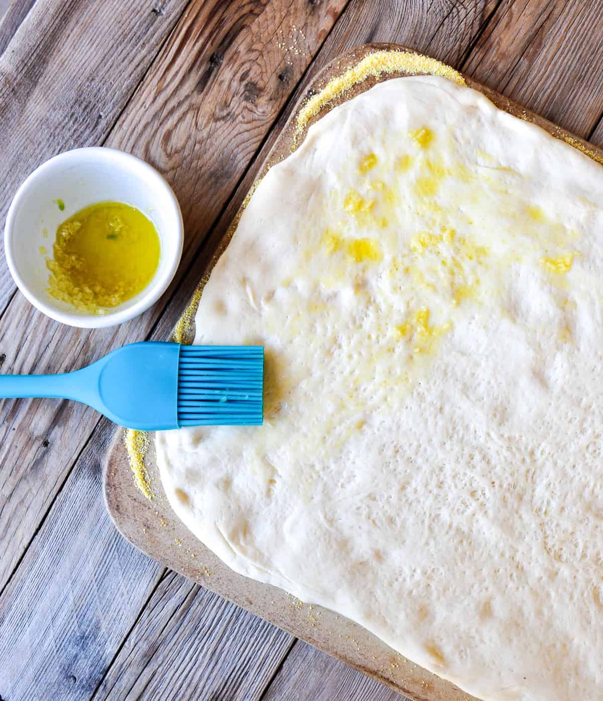 Brush the dough with garlic-olive oil mixture