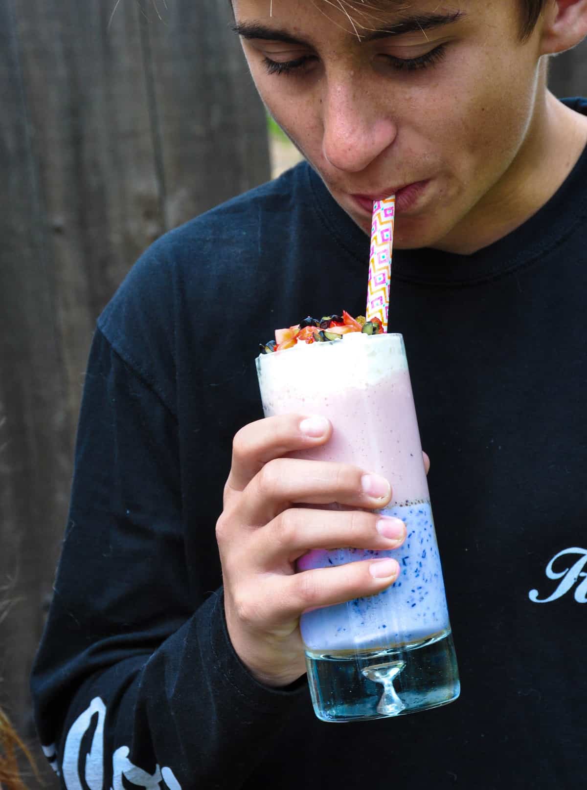 Boy drinking unicorn smoothie