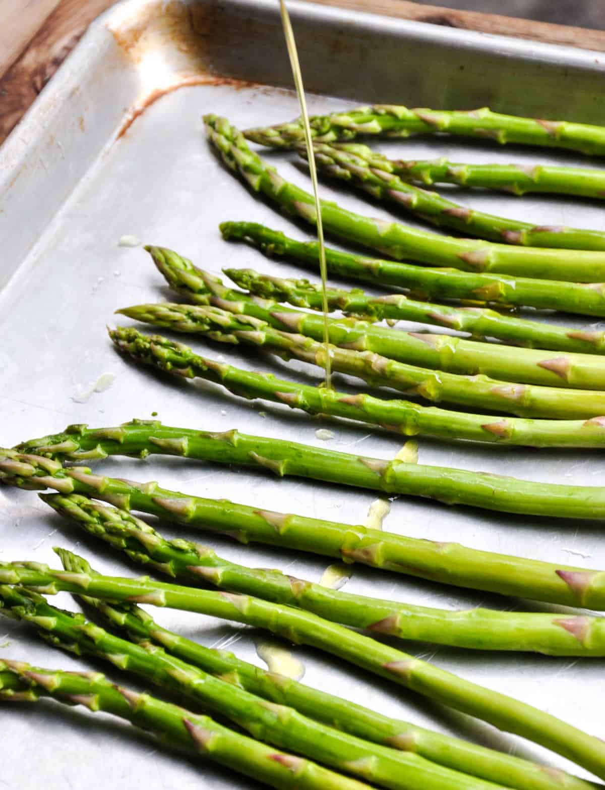 Olive oil drizzled on asparagus
