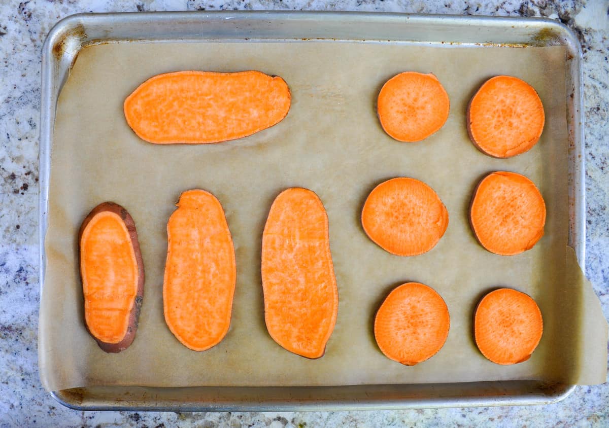 Line sliced sweetpotatoes to baking sweet with parchment paper