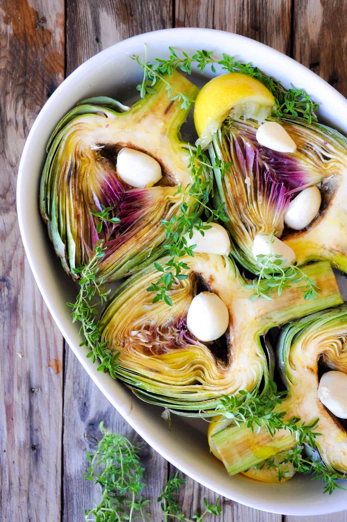 Add sprigs of thyme over artichokes