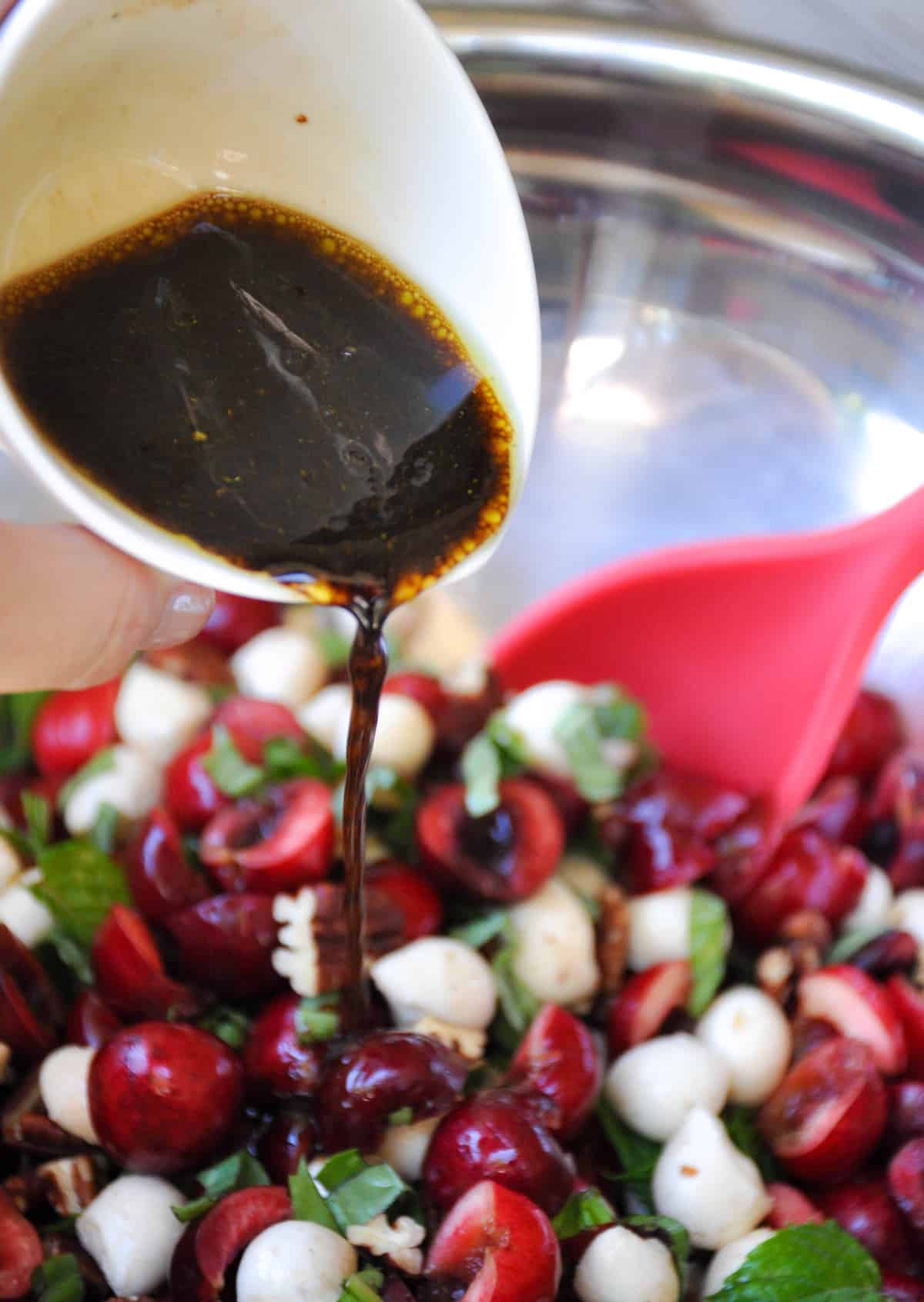 Pour balsamic over ingredients 