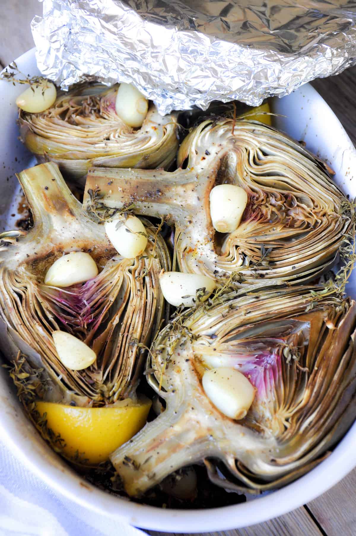 Bake artichokes with foil over dish pan