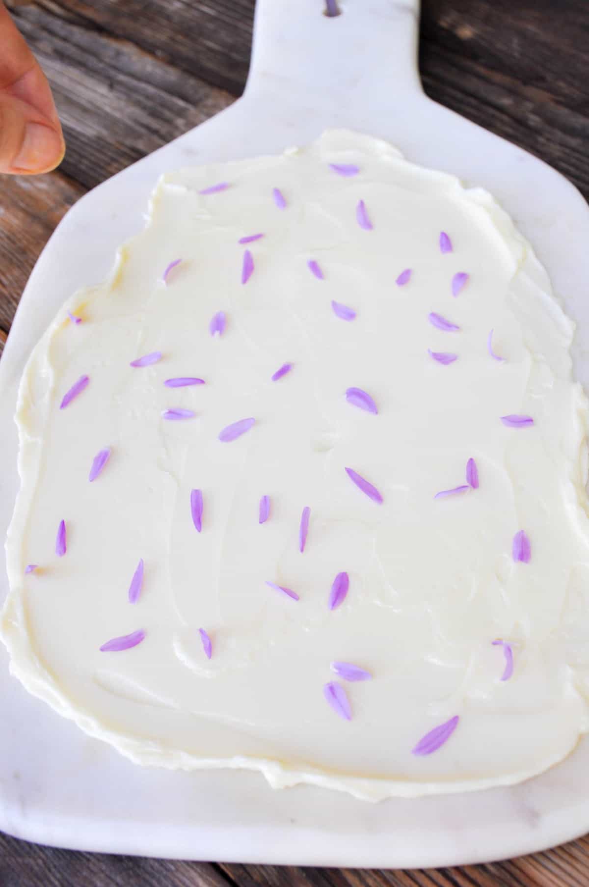 Add edible flowers onto butter