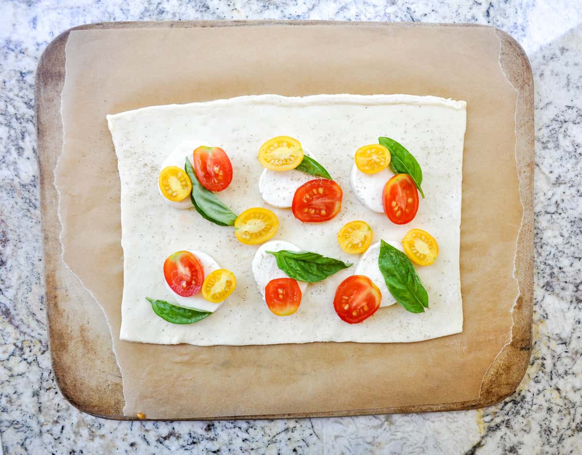 Halved tomatoes on dough