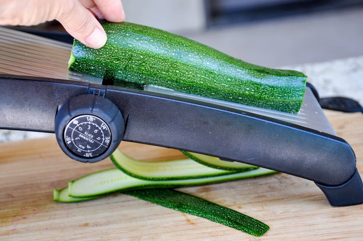 Slice zucchini using mandoline 