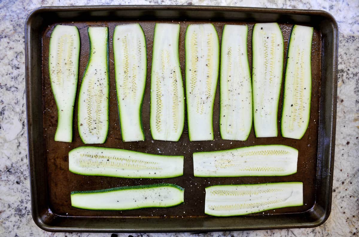 Sliced zucchini on baking sheet
