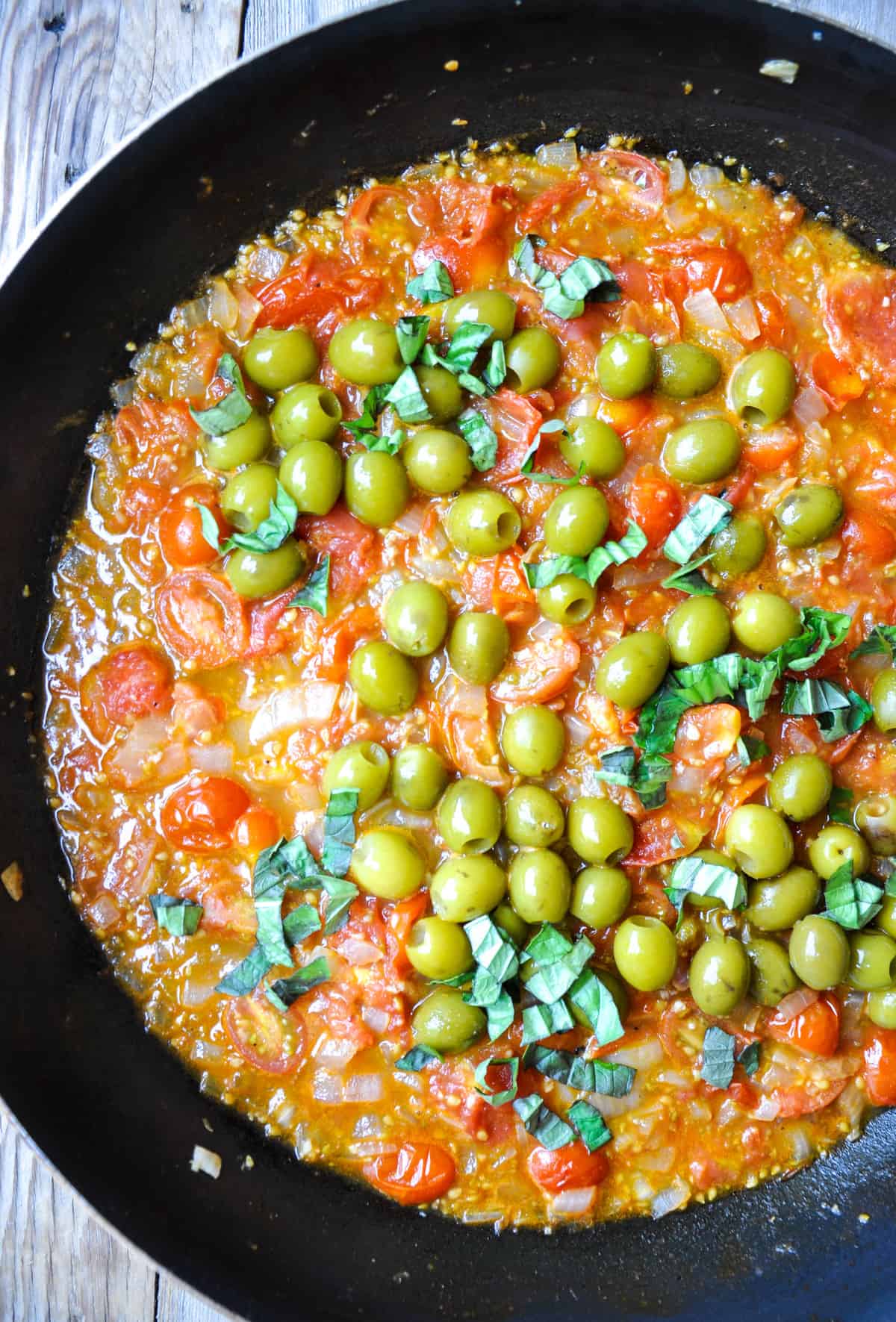 Add in green olives and fresh, chopped basil