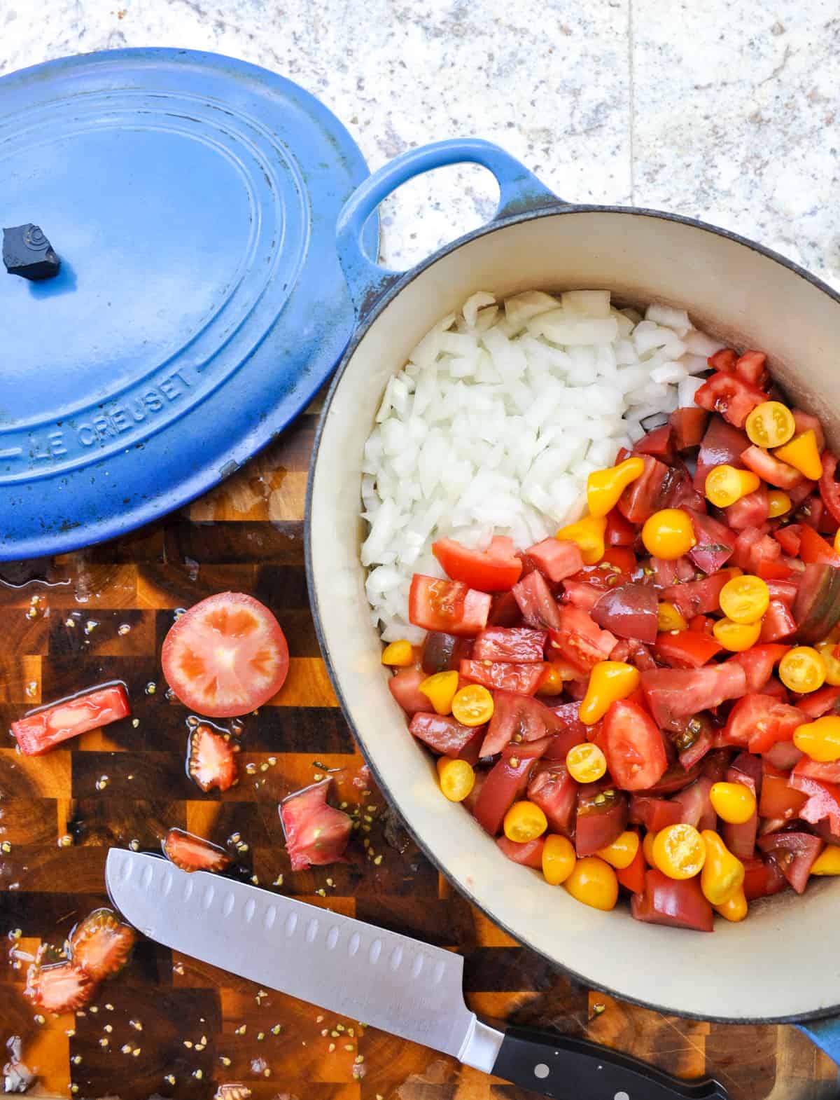 Chopped tomatoes and onion in pot