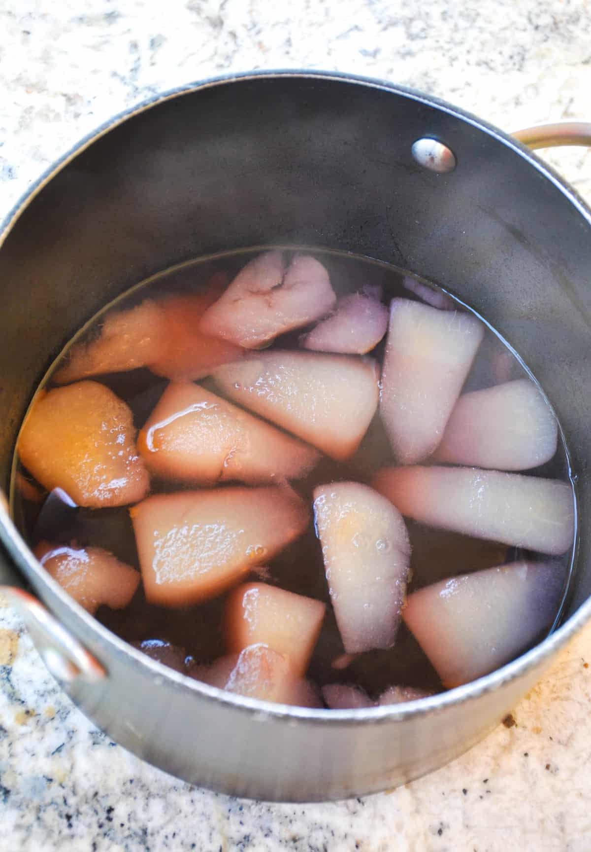 Pears and rose in saucepan 