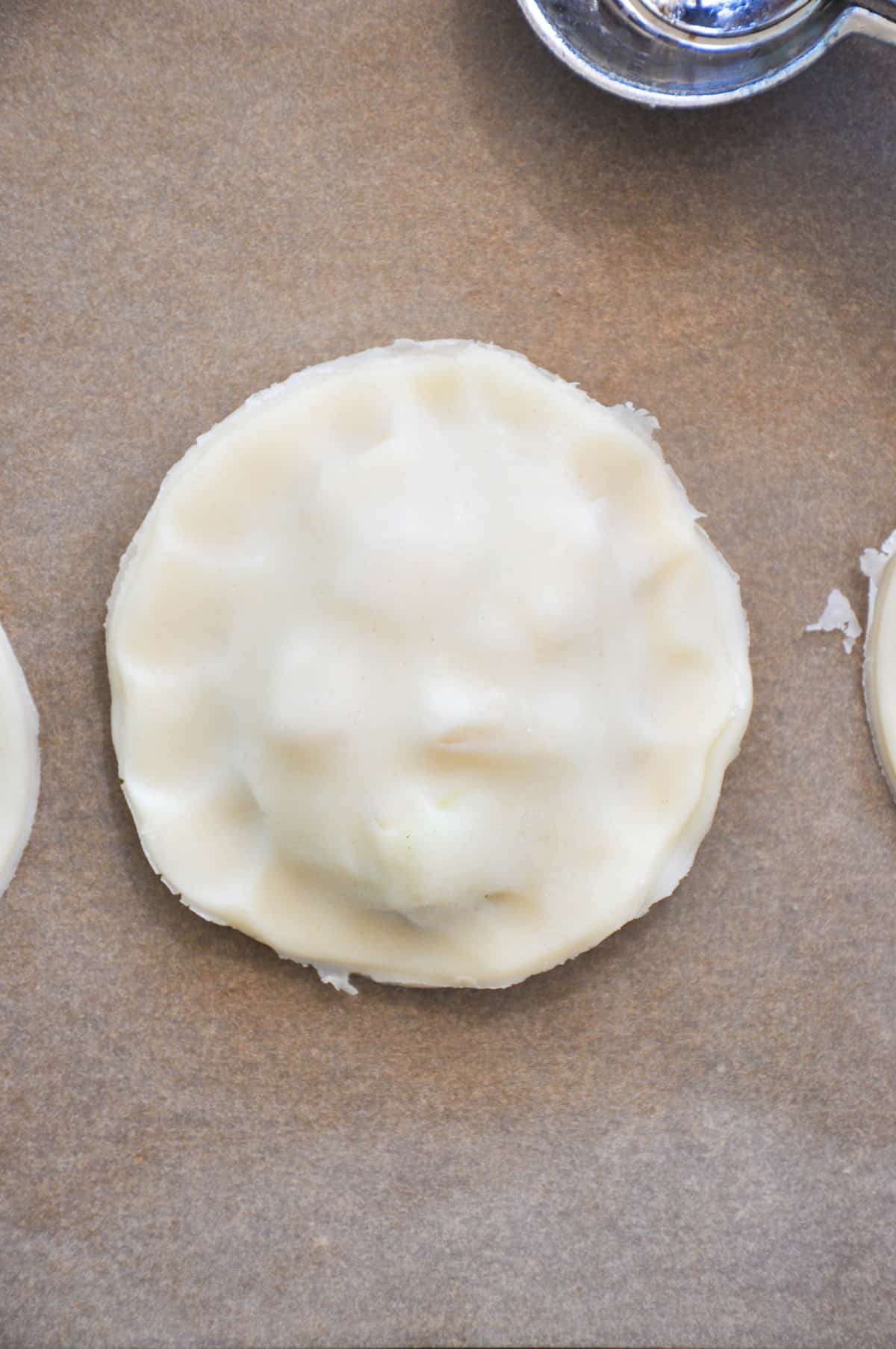 Place the pie crust round on top of the filling