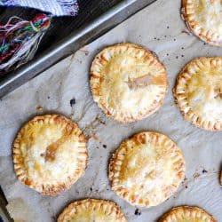 Baked Caramel Apple Hand Pies on a baking sheet.