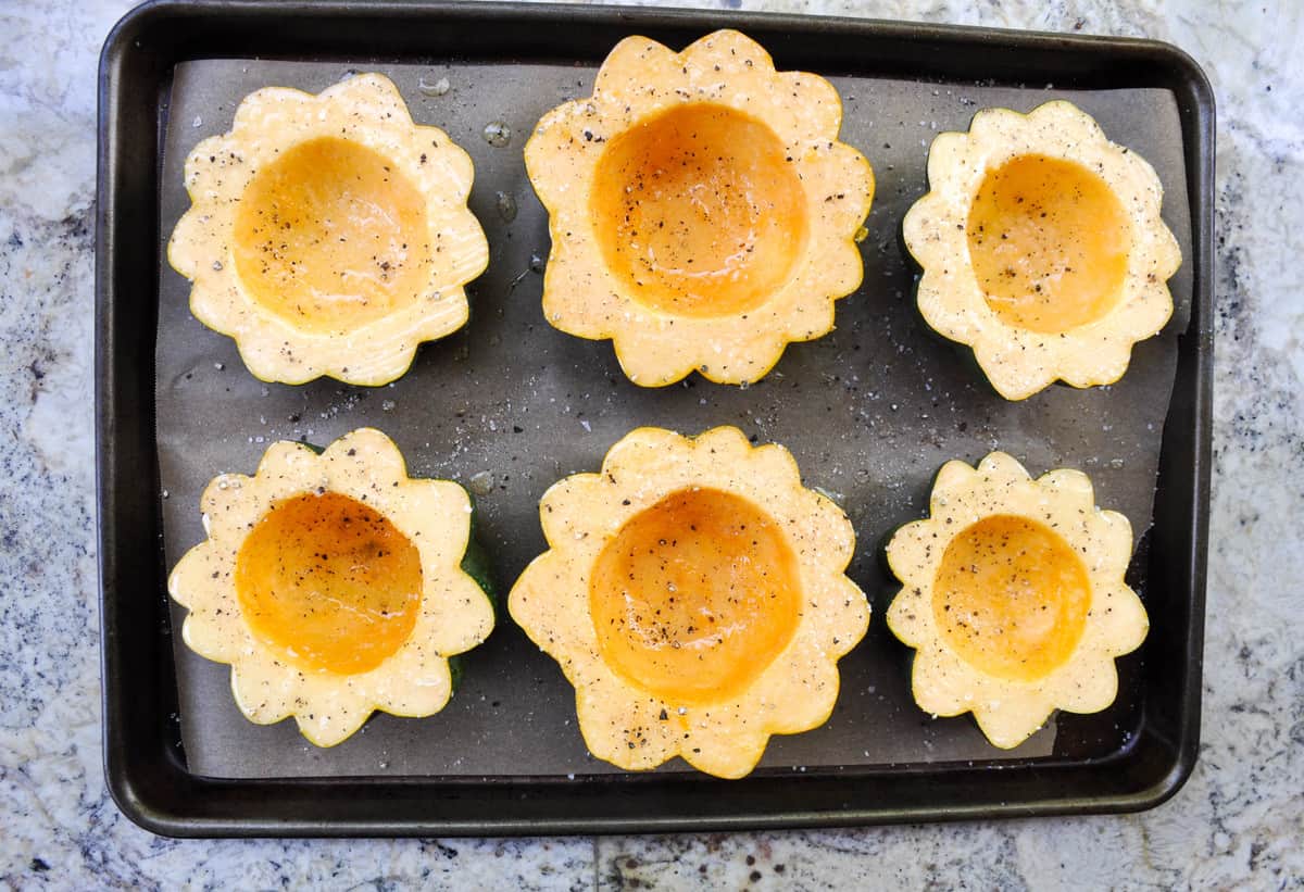 Brush acorn squash with butter and dust with salt and pepper