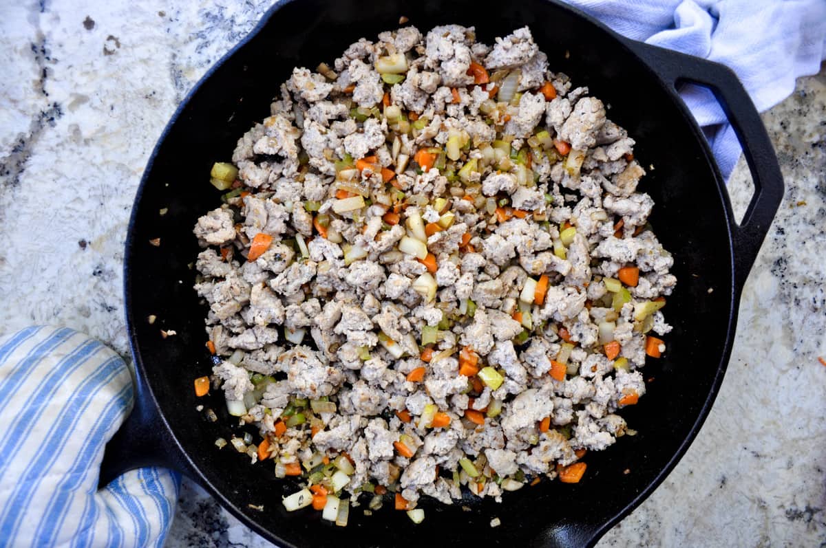 Ground turkey, onion, carrot, celery, mushroom and Bartlett pear in skillet