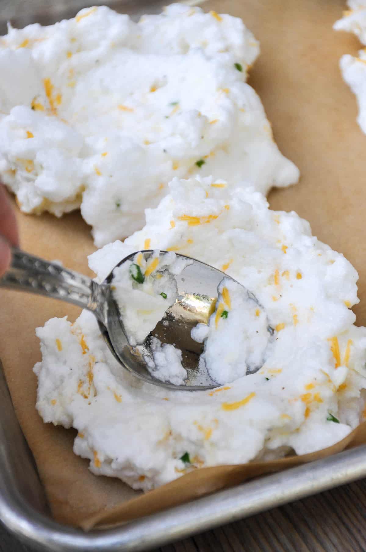 Scoop the whites onto a parchment lined baking sheet, creating the "clouds" and push the center of each cloud down to make a well for the yolk.