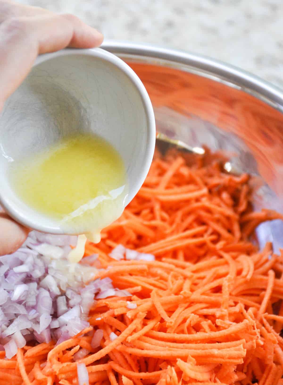 Add melted butter to shredded sweetpotato and chopped shallot