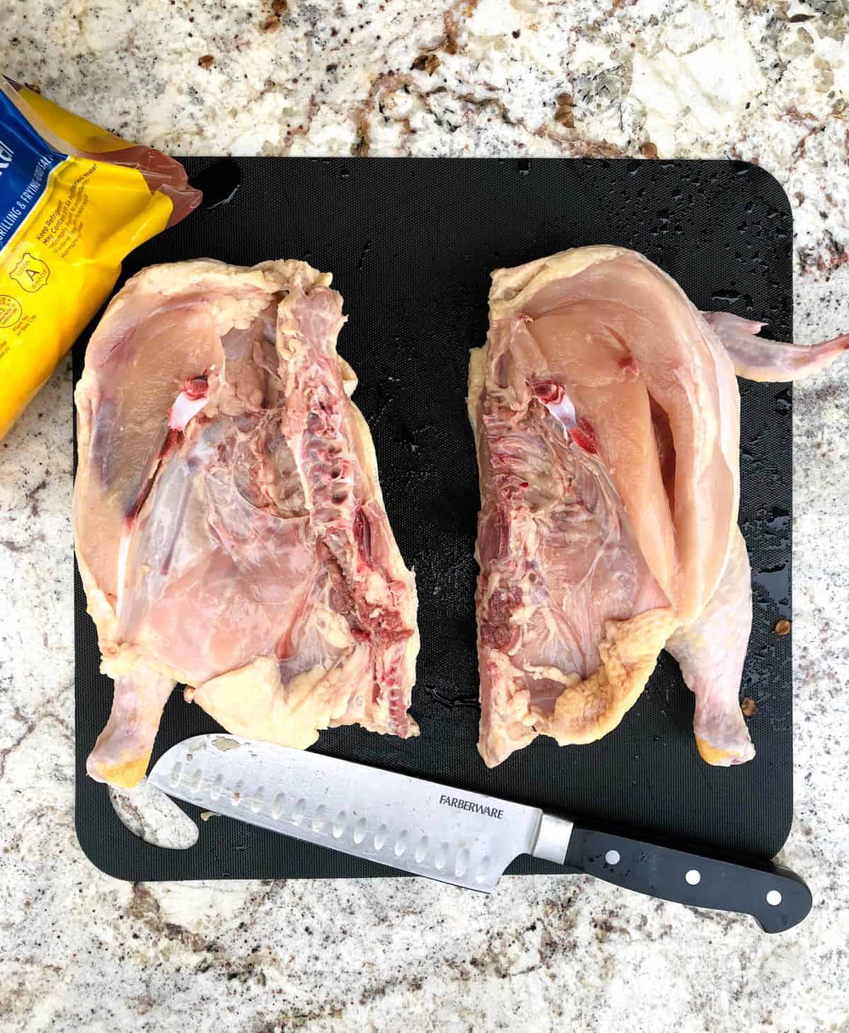Cut whole chicken down the middle. 