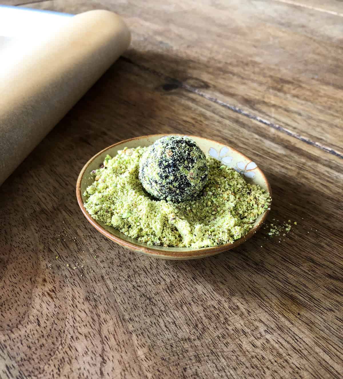 Drop ball into pistachio dust 