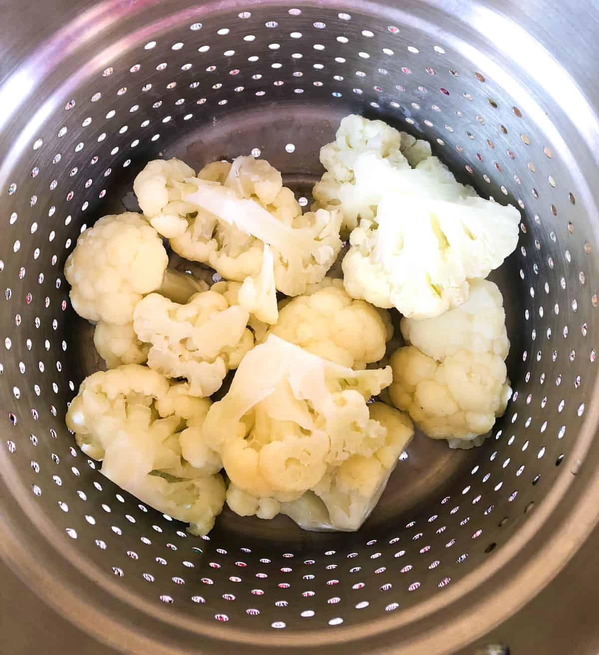 Steam cauliflower chunks for ten minutes or until tender. 