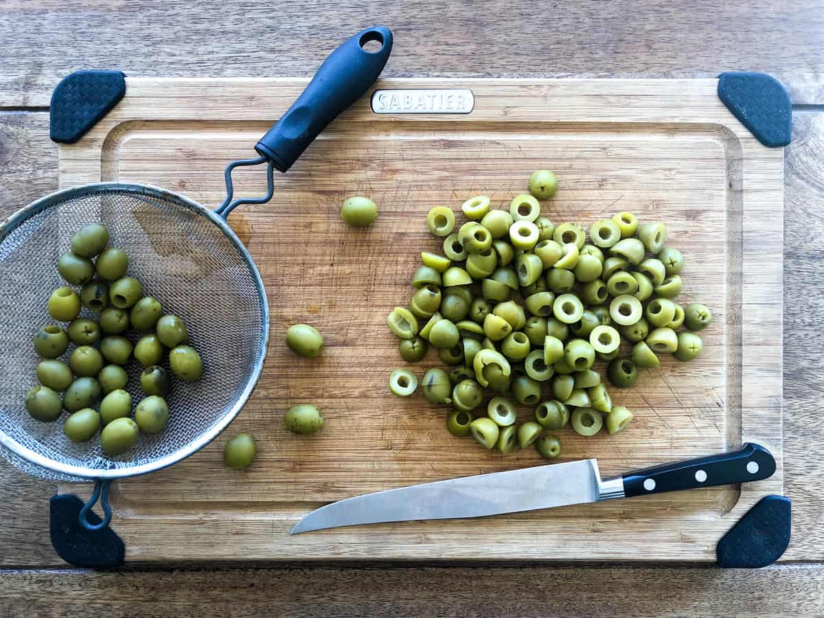 Slice each olive in half. 