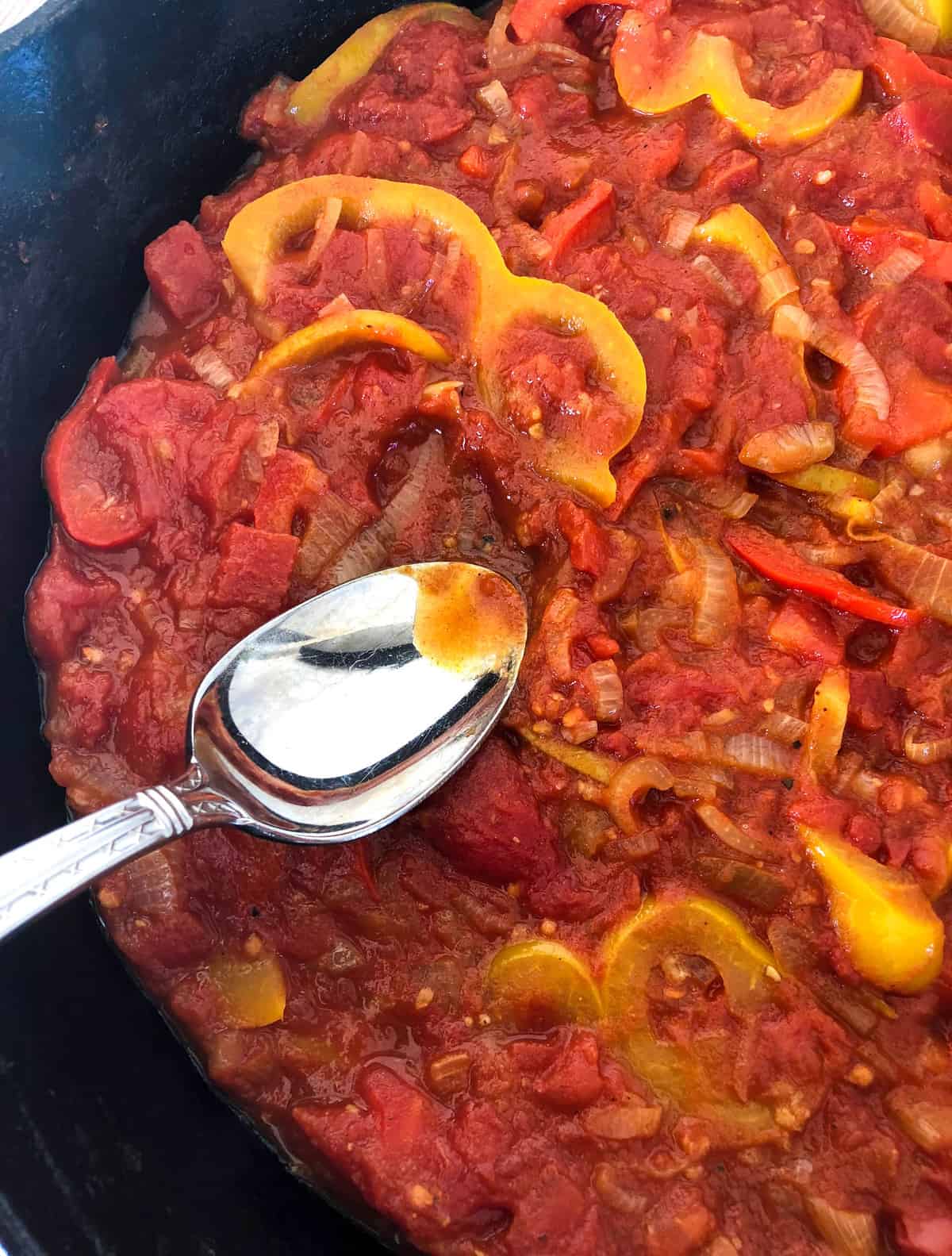 Canned tomatoes added to skillet