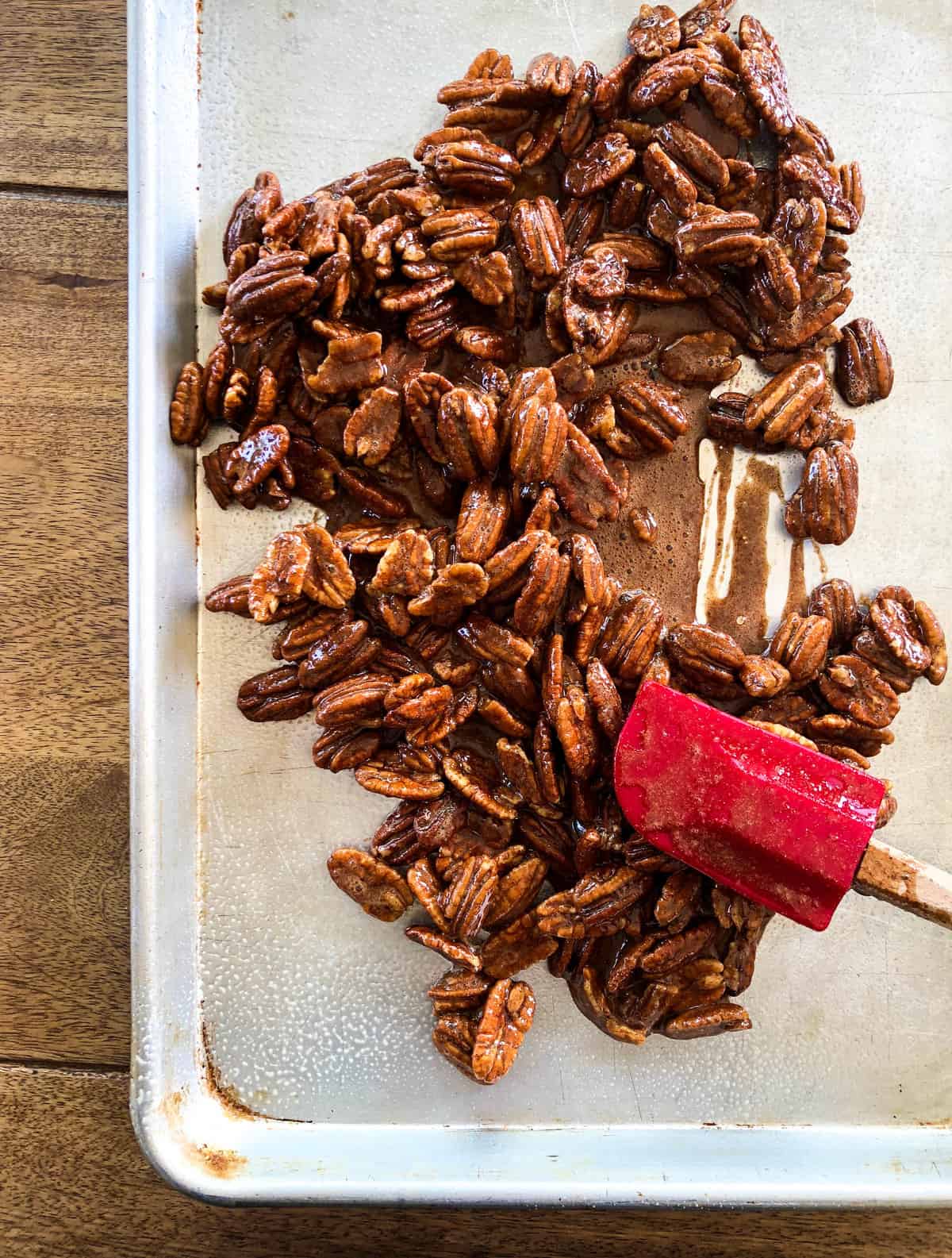 Add the nuts and spread onto a prepared baking sheet.