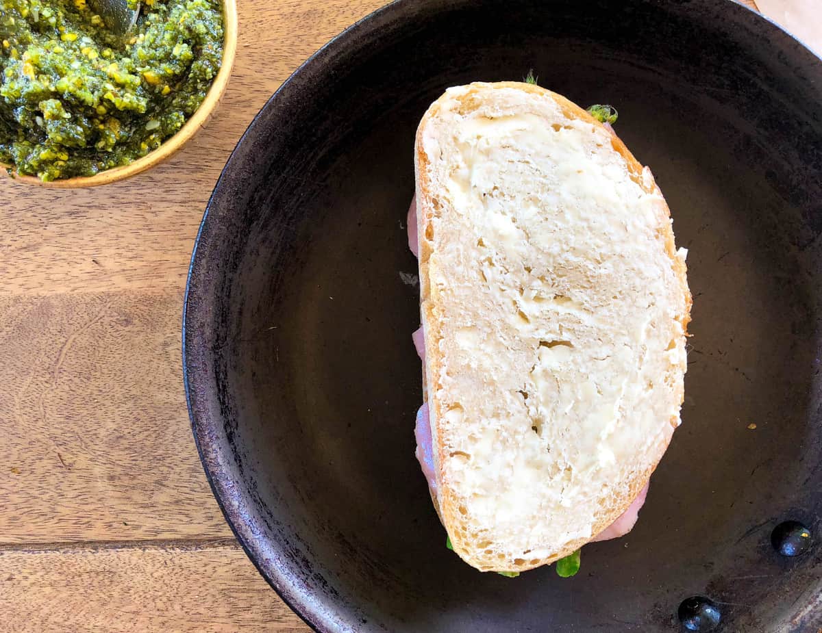 Place the other bread slice, buttered side up, on top and cook over a medium heat burner