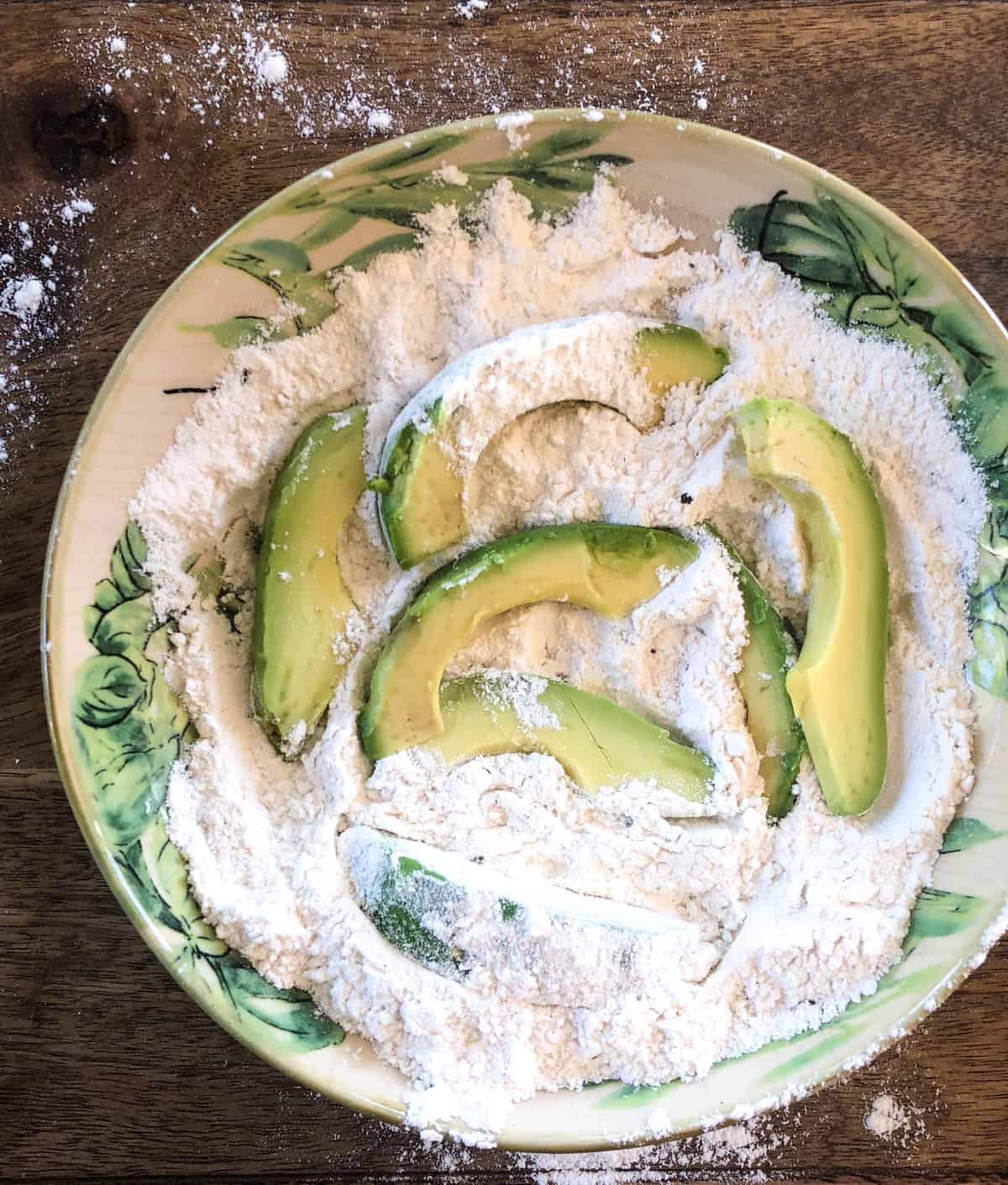 Coat avocados in seasoned flour