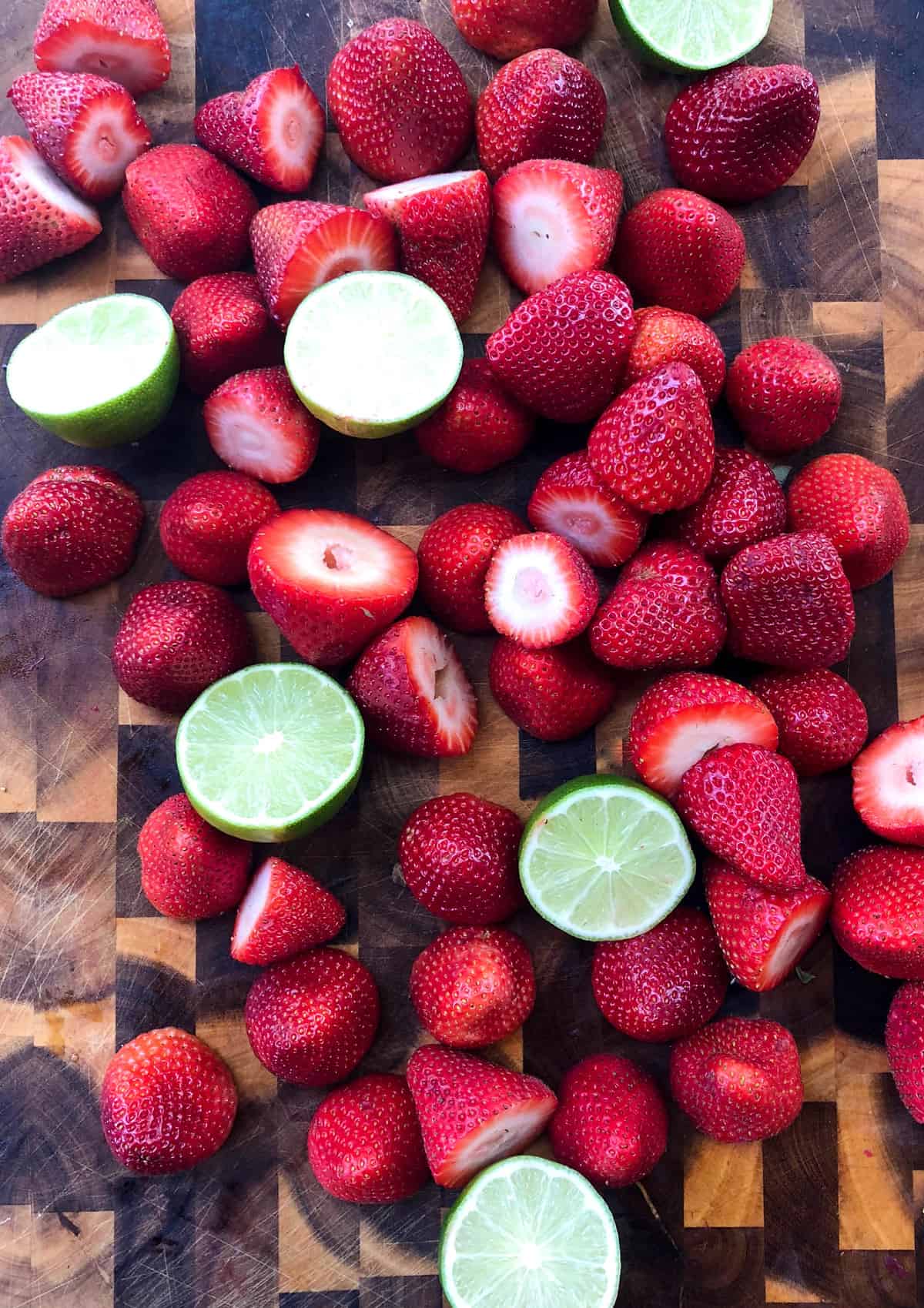 Halved limes and strawberries with tops removed 