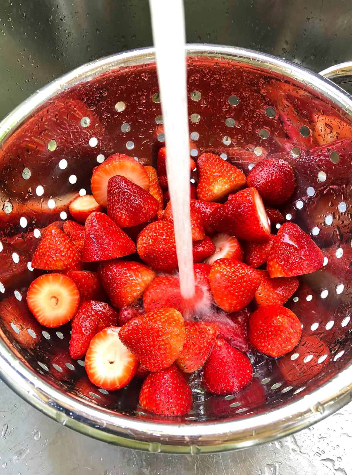 Rinse the strawberries thoroughly under cold running water