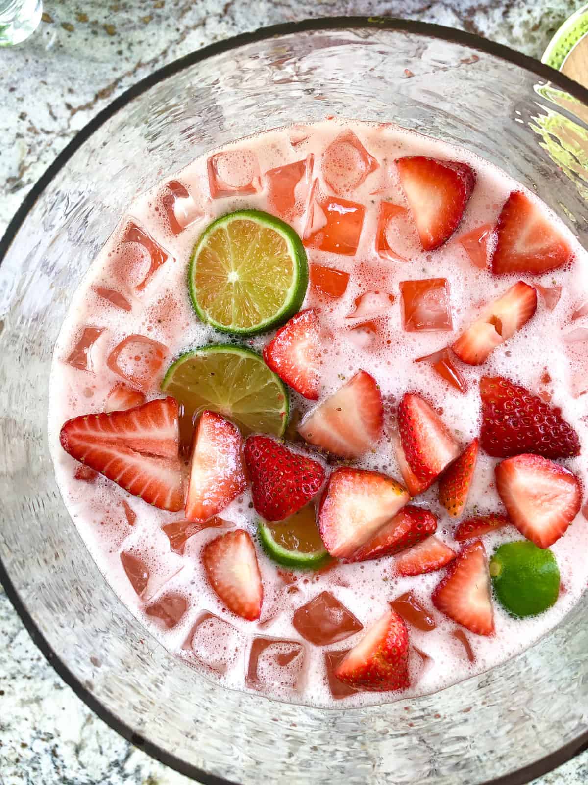 Top it with sliced strawberries and limes, and serve!