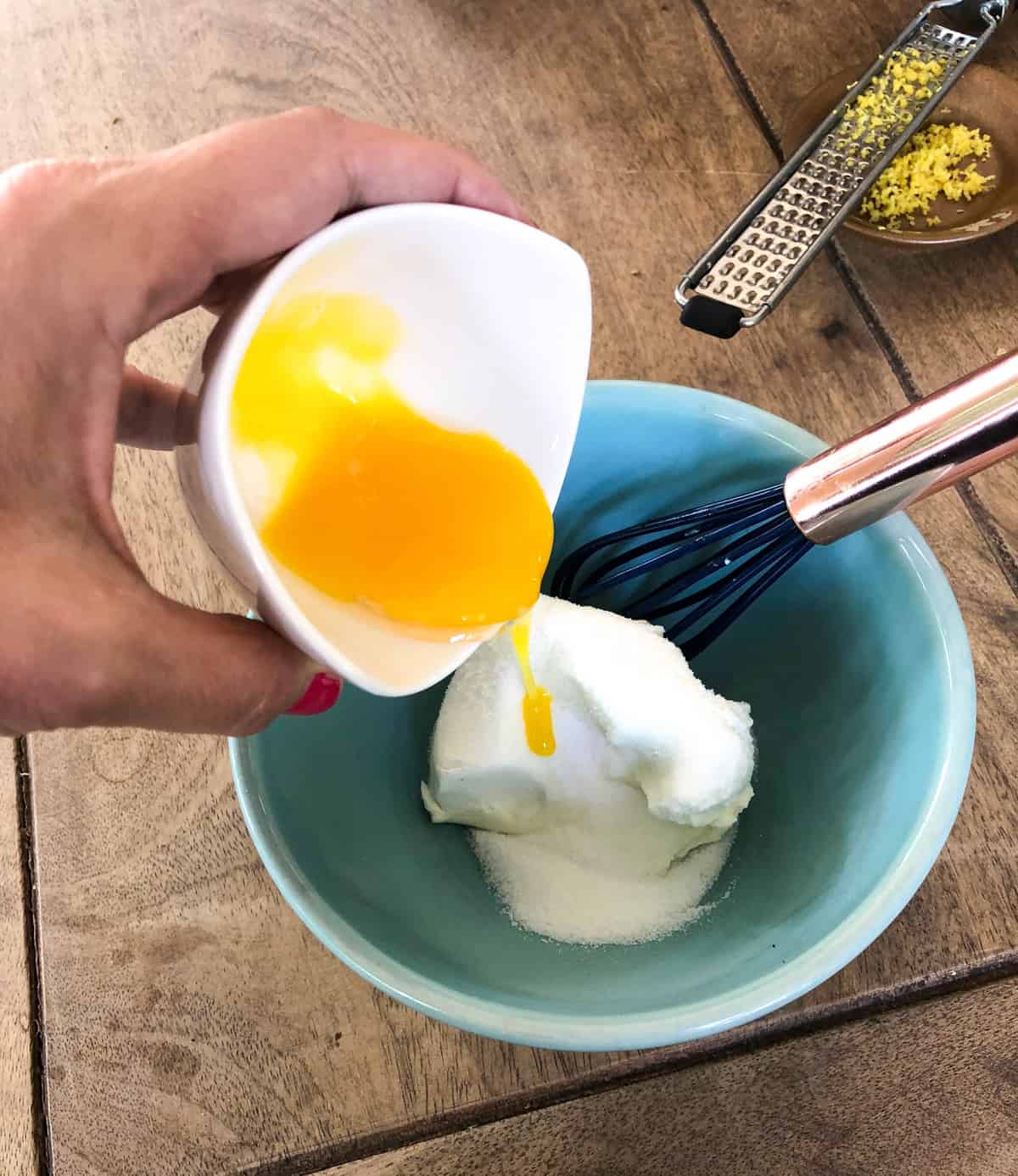 add the cream cheese, sugar, egg yolk, and half the lemon zest to another bowl and mix until well combined.