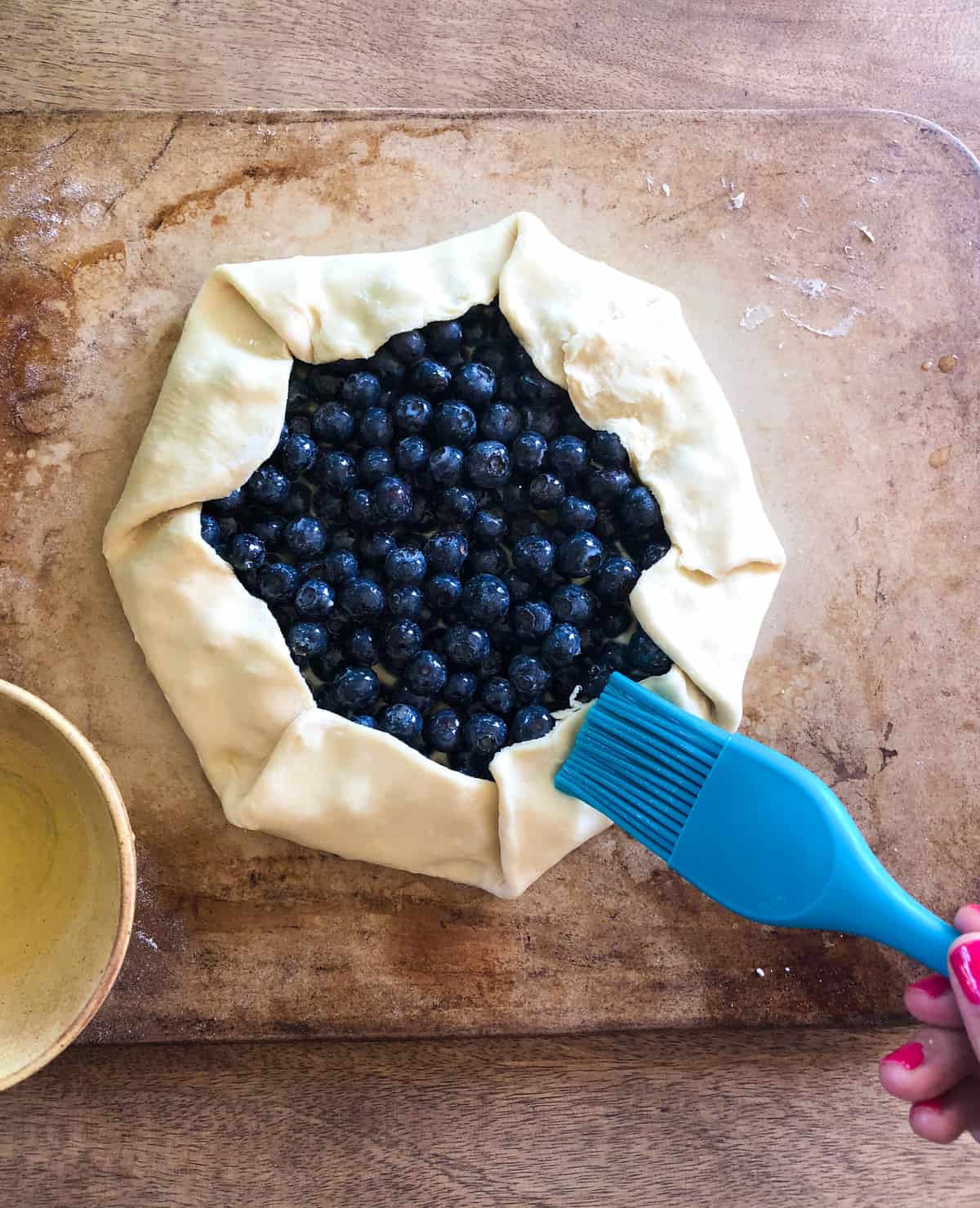 Brush the dough with egg white and dust with turbinado sugar. 