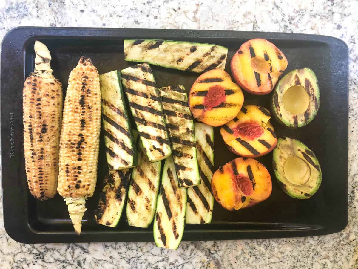 Grill the corn, zucchini, peaches and avocado on a super hot grill.