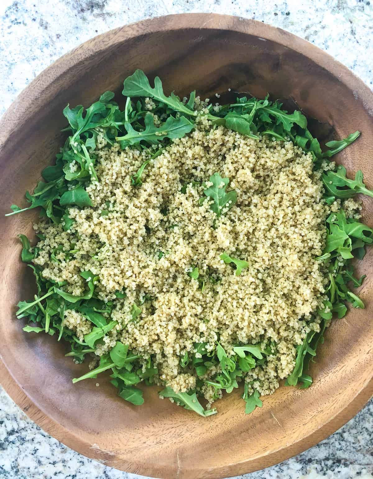 Add 2 cups of cooked, cooled quinoa to arugula base. 