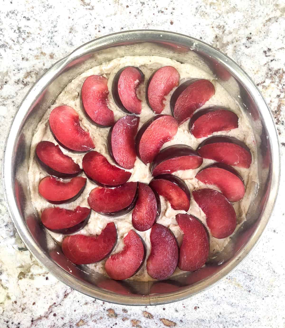 Arrange your quartered black plums in a beautiful pattern over the batter.