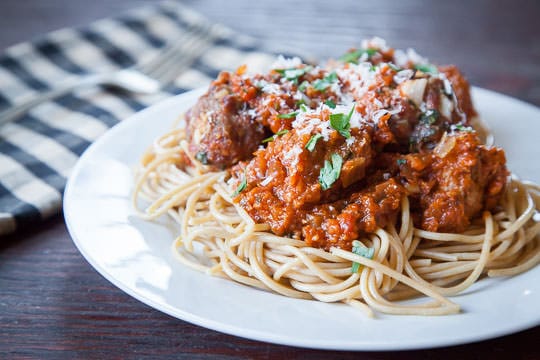 A plate of Spaghetti and Meatballs with Roasted Tomato Sauce . This classic tomato recipe is topped with Parmesan cheese and basil.