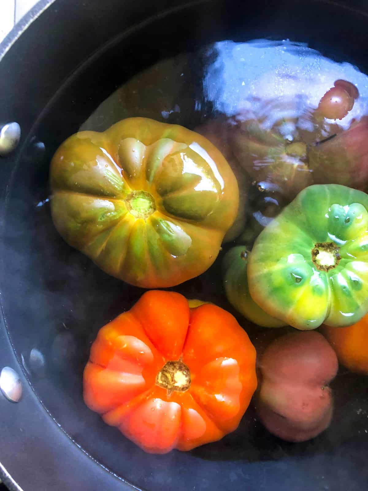 Place the tomatoes in a bath of boiling water for about a minute.