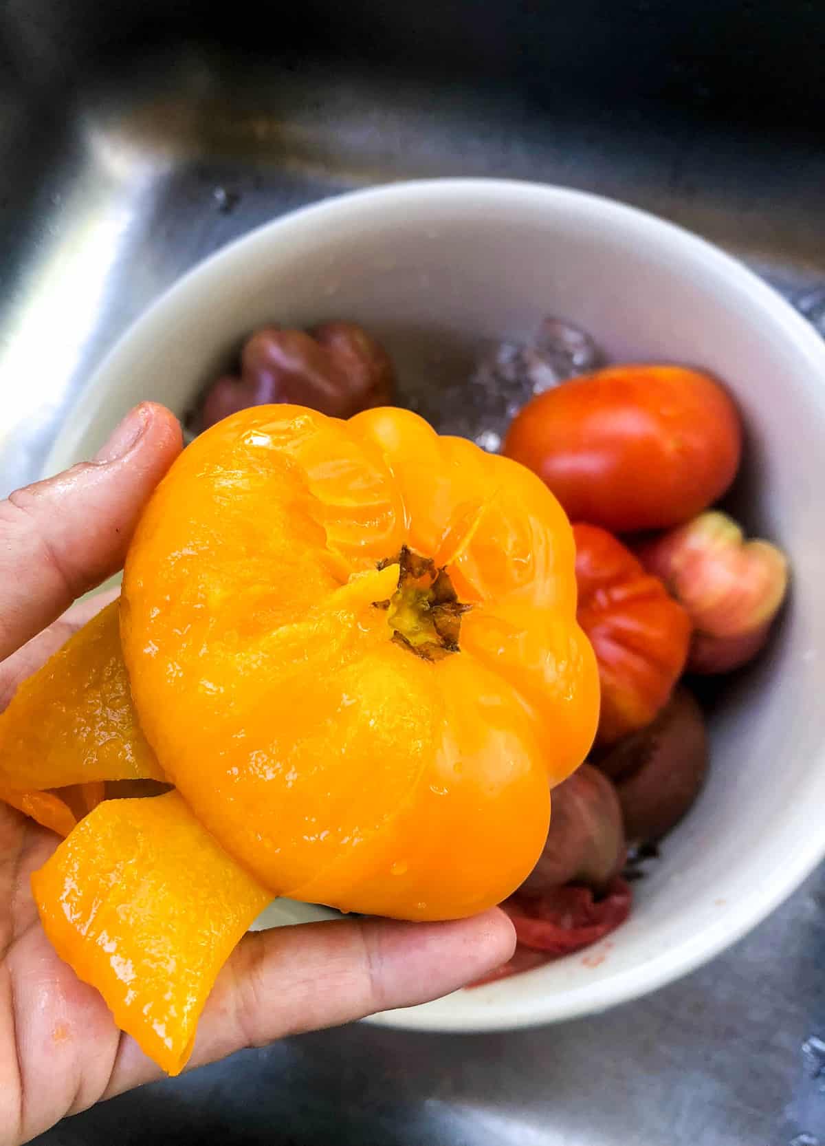 When cooled, you can easily peel the skin away from each tomato.