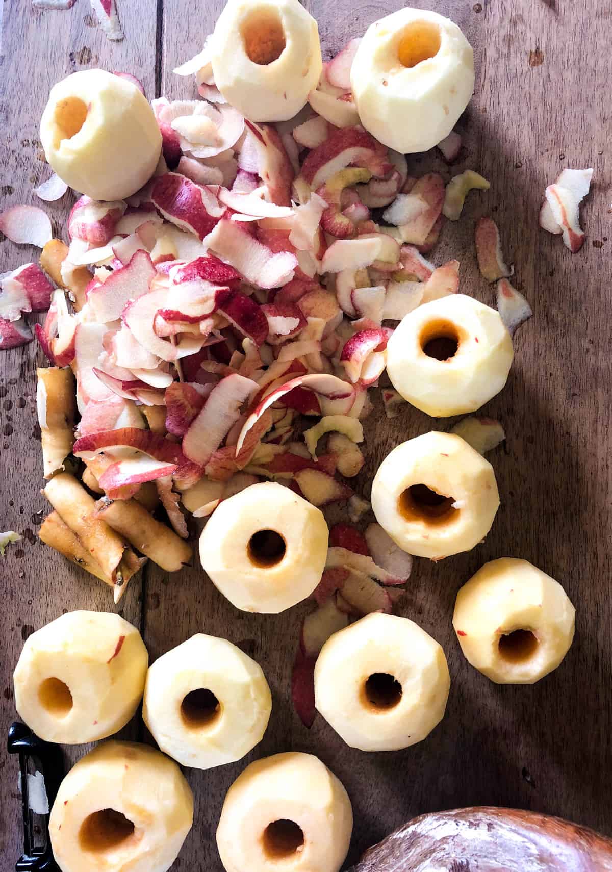 using a vegetable peeler, peel all the apples.