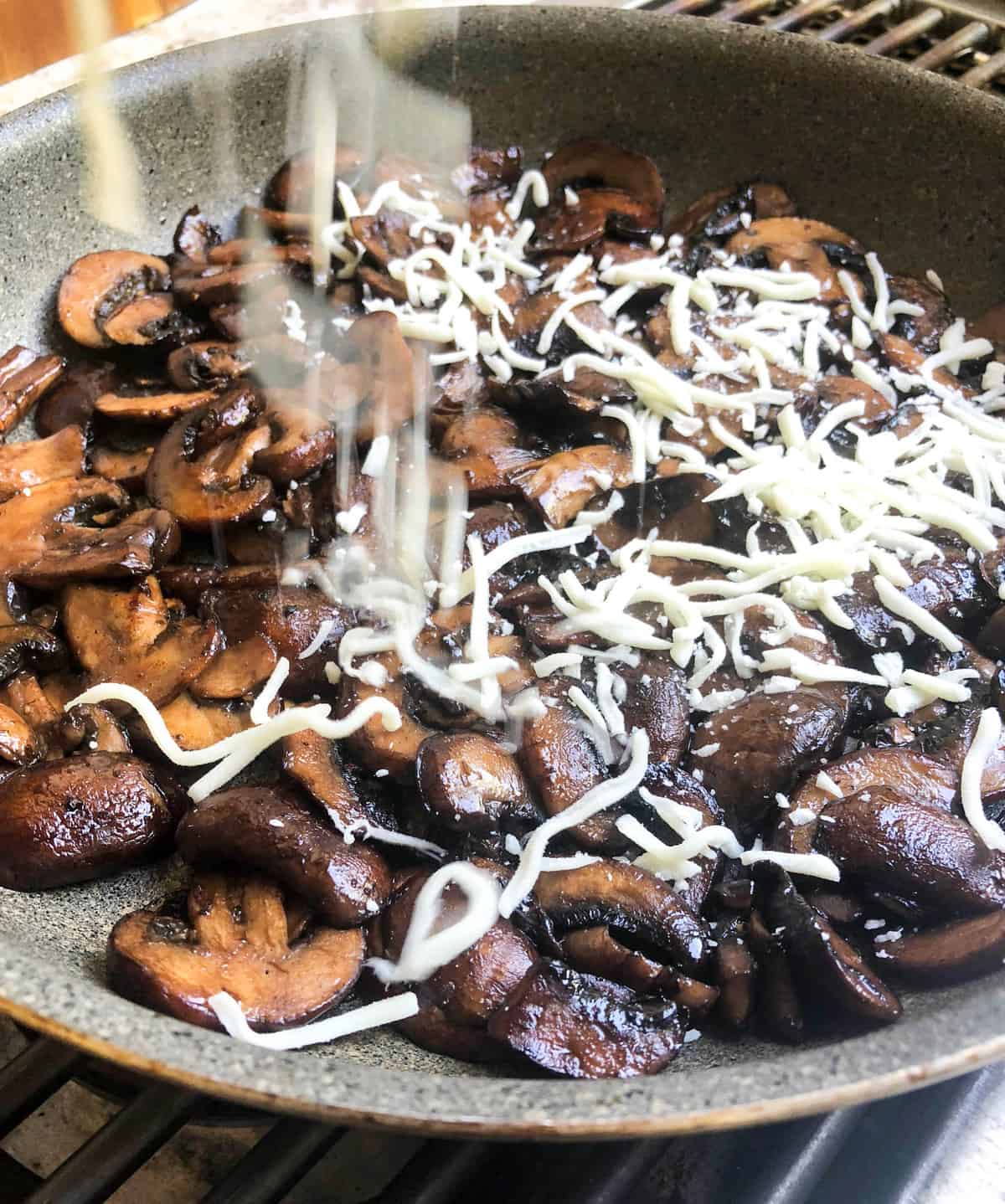 Pull the pan off the heat and top with shredded mozzarella cheese. Place under the broiler for a few minutes until the cheese has crisped up and the surface is golden.