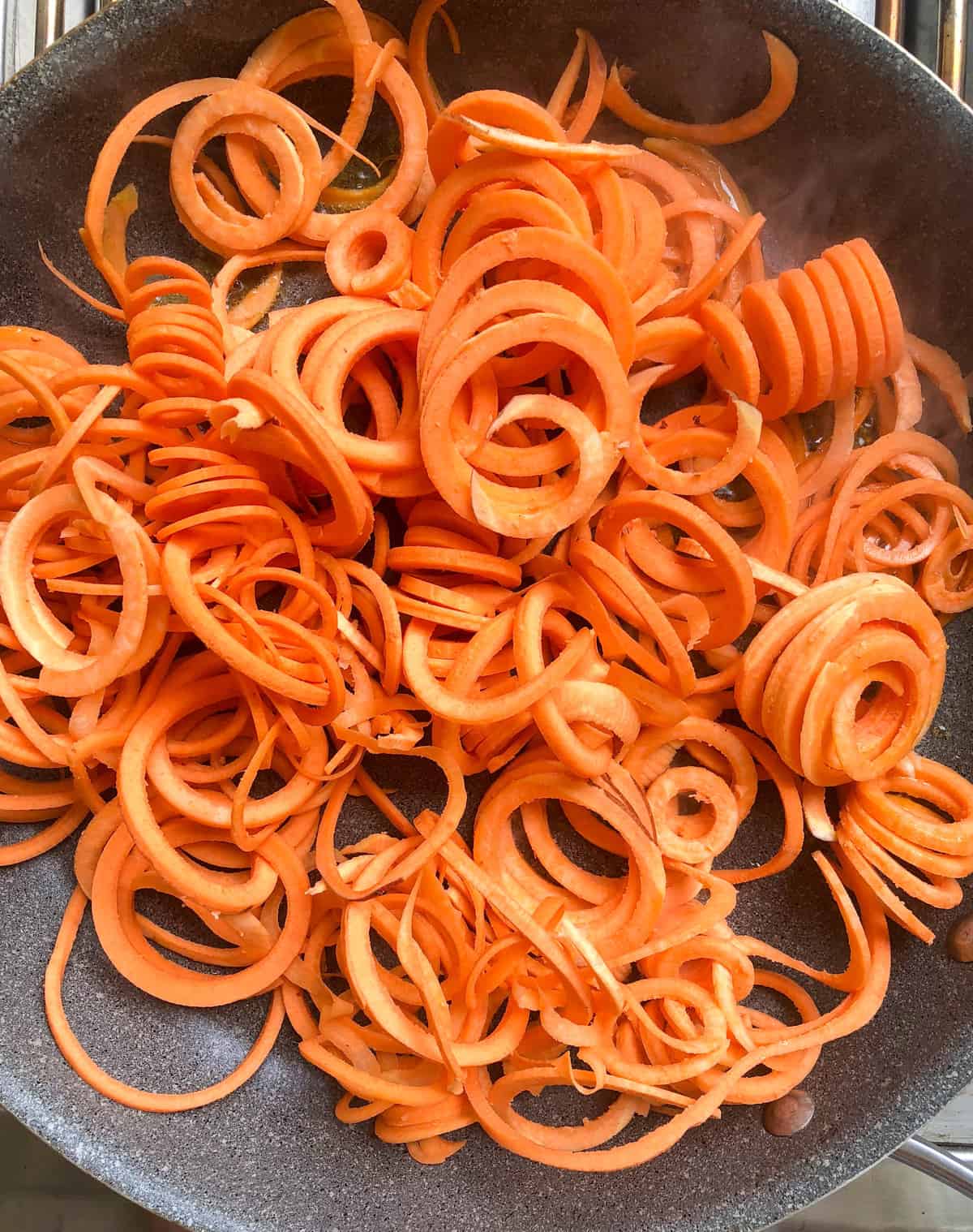 Add the spiralized sweetpotatoes to the pan and sauté for 5-7 minutes.